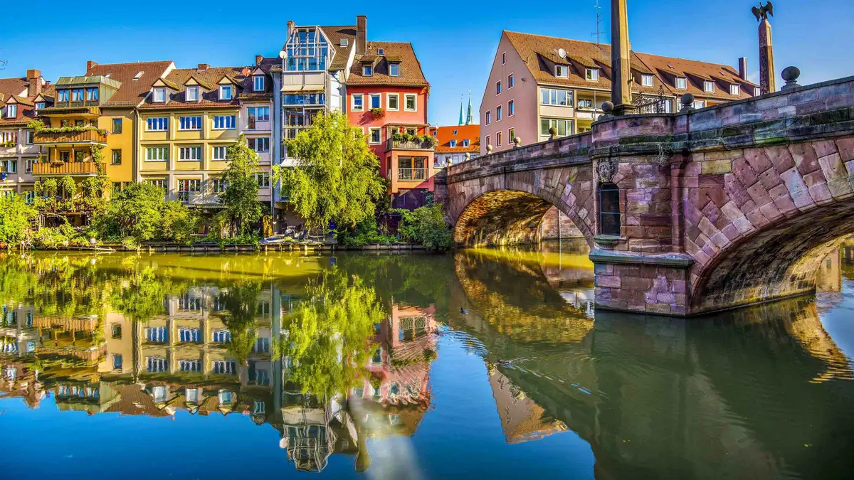 Half-timbered houses along the Pegnitz river in Nuremberg reflected in calm water